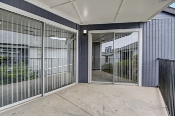 A modern building entrance with a glass door and a metal fence.